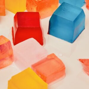 Vibrant, multicolored ice cubes on a white background